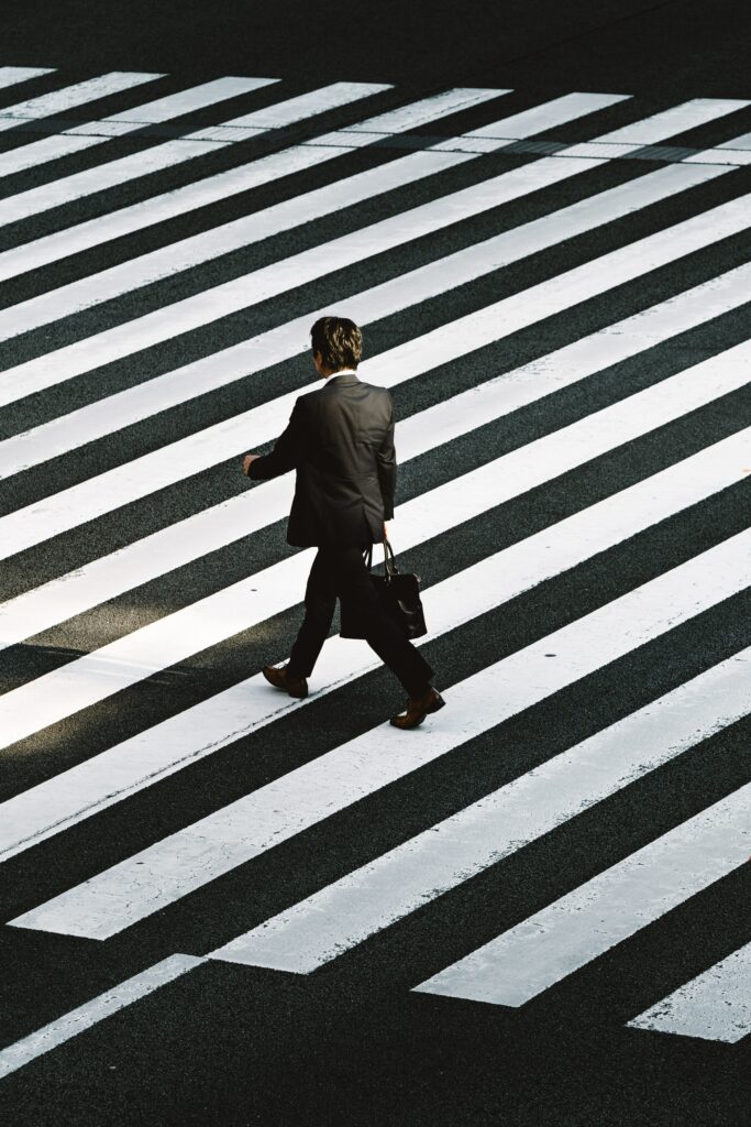Person crossing road on a zebra crossing. 